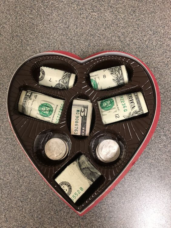 money gift inside chocolate box heart shape
